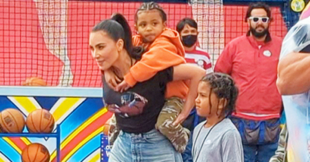 Kim Kardashian carries son on her back