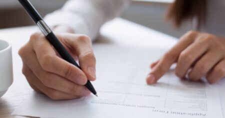 Applicant Signing a Form